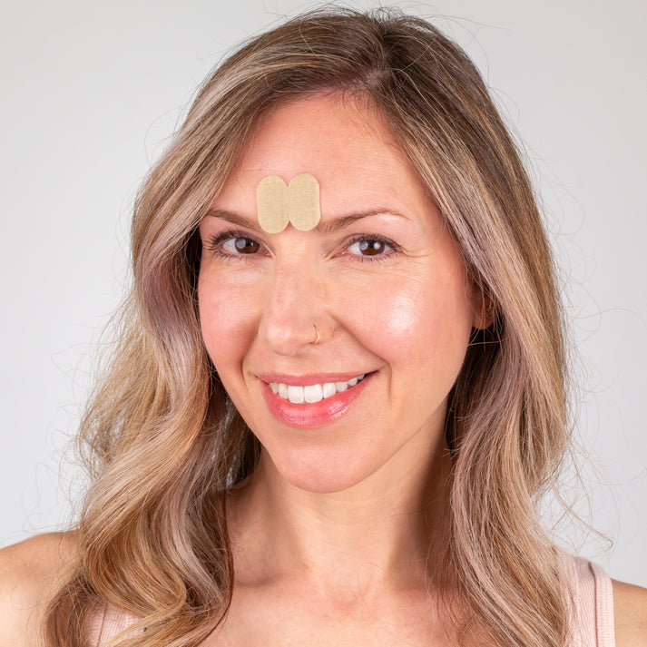 Smiling woman showing skin after using Frownies Gentle Lifts