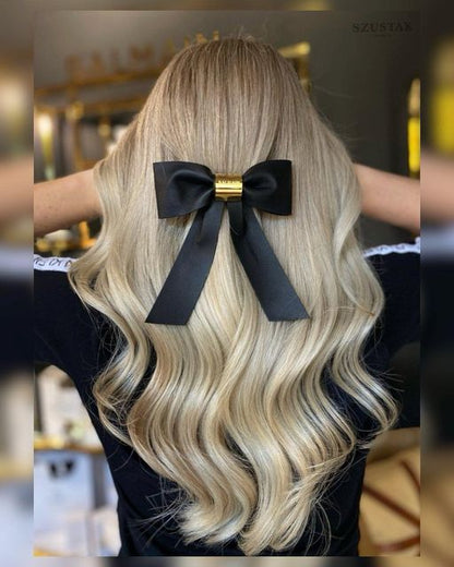 Balmain Hair Couture | Leather Barrette Bow with 18K Gold Detail in blonde wavy hair